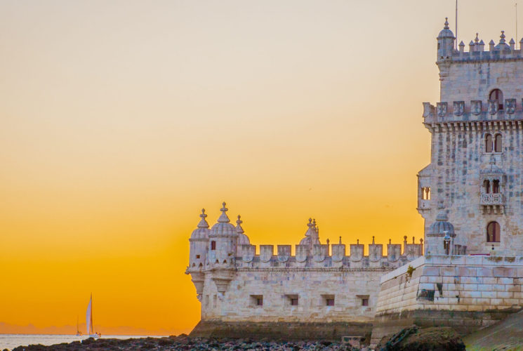 Belém Tower with a sunset in the background.